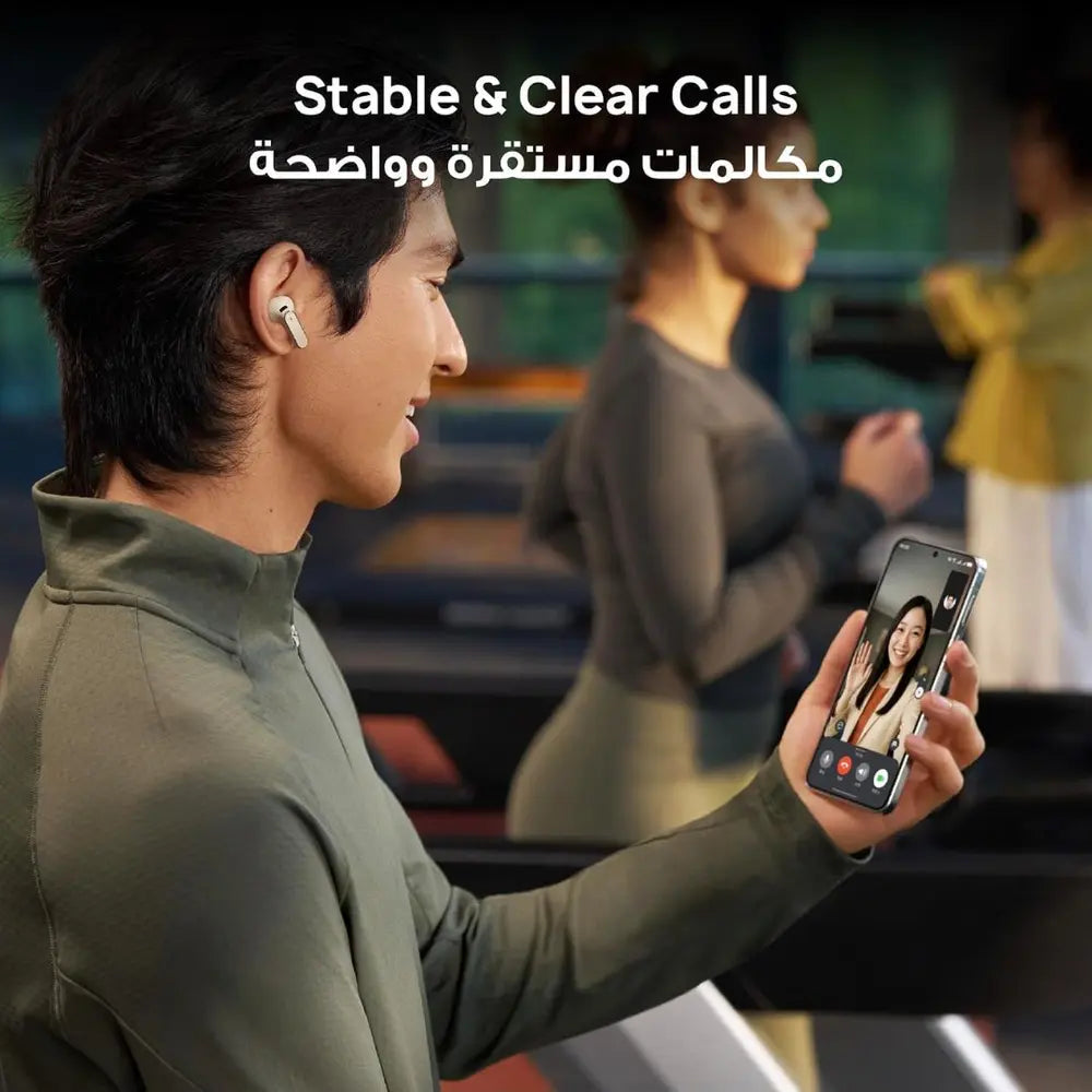 Person using HUAWEI FreeBuds Pro 5 during a phone call in a busy public setting.