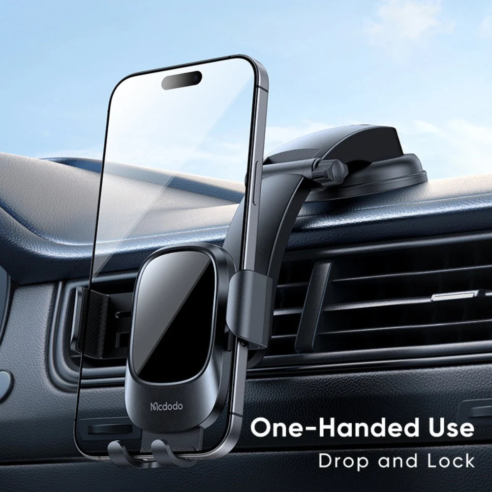 Mcdodo CM-7220 universal car phone holder mounted on a dashboard holding a smartphone in portrait orientation